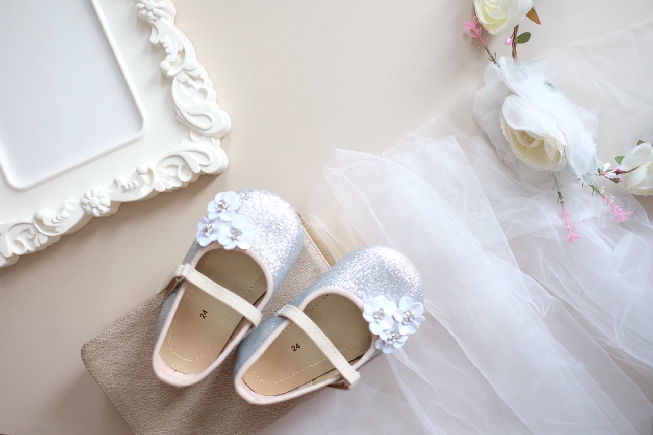 HIGH ANGLE VIEW OF VARIOUS SHOES ON WHITE FLOOR