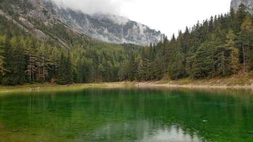 Calm countryside lake against mountain range