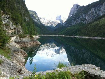 Scenic view of lake and mountains against sky