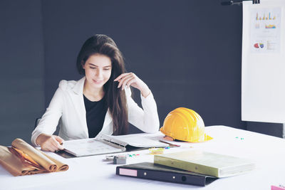 Young woman using smart phone on table