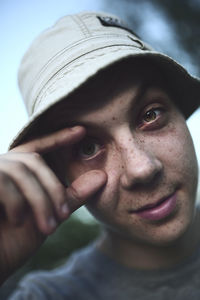 Close-up portrait of young man wearing hat