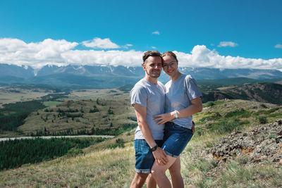 Portrait of smiling man on mountain against sky