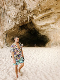 Man looking away while standing at beach