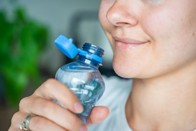 Close-up of woman holding bottle