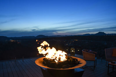 Flowers on table against mountain at dusk