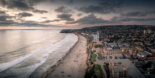 Pacific beach in san diego with beachfront homes and motels. muted colors.