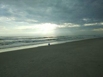 Scenic view of beach against sky during sunset