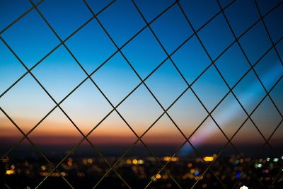 Close-up of chainlink fence against sky