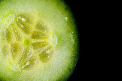 Close-up of lemon slice over black background