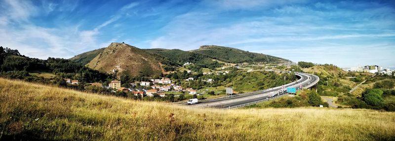 Panoramic view of road by mountains against sky