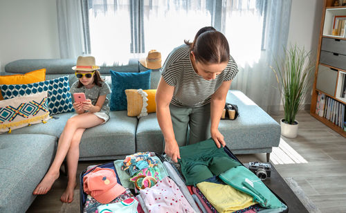 High angle view of mother and daughter sitting at home