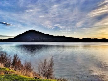 Scenic view of lake against sky during sunset