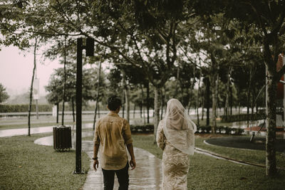 Rear view of women walking in park