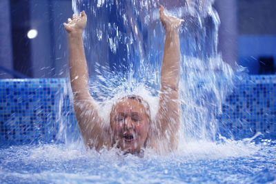 Woman enjoying in swimming pool at water park