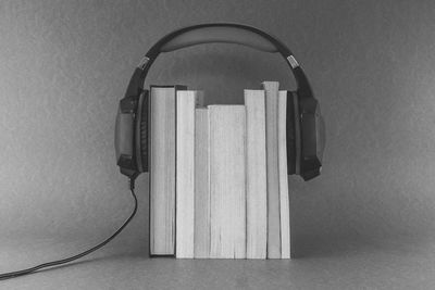 Close-up of open book on table against wall