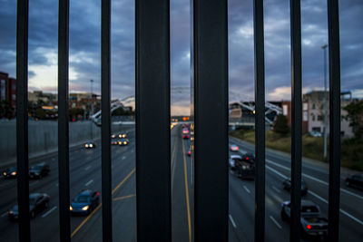 Close-up of railing against sky in city