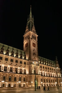 Low angle view of illuminated building against sky at night