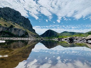 Scenic view of lake and mountains against sky