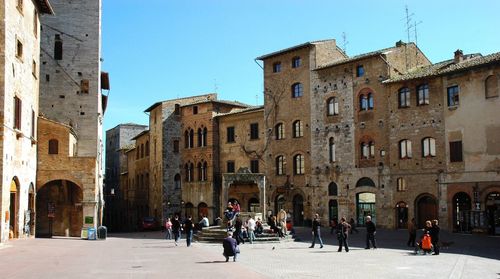 People against buildings in city