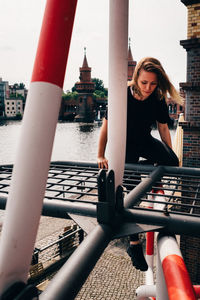 Full length of woman on railing in city