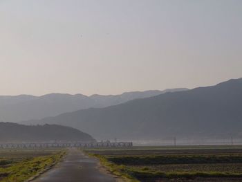 Country road leading towards mountains