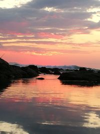 Scenic view of sea against romantic sky at sunset