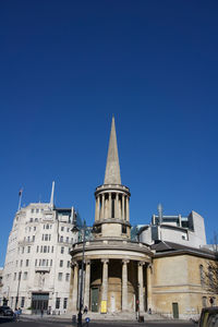 Low angle view of buildings against blue sky