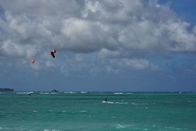 People kiteboarding on sea