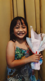 Portrait of smiling girl holding camera