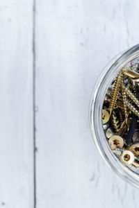 Directly above shot of screws in jar on table