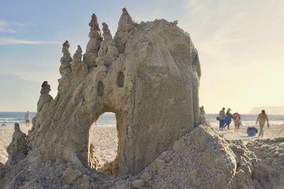 Sand castle at beach during sunset