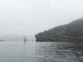 Scenic view of lake against sky during rainy season