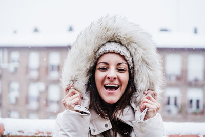 Portrait of smiling young woman in city