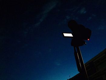 Low angle view of street light against blue sky