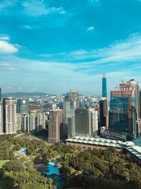 High angle view of buildings against blue sky