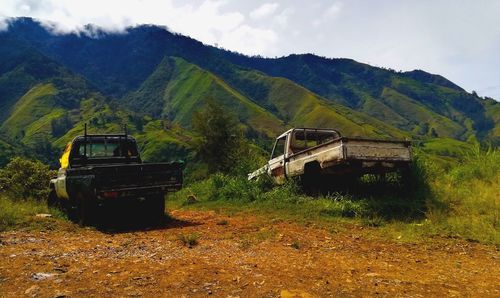 Abandoned truck on field against sky