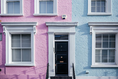 Pastel pink and blue painted townhouse facade