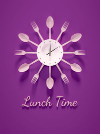 Optical illusion of clock made with plate and cutlery over purple background