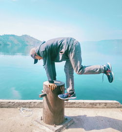 Man by sea against sky