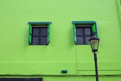 Low angle view of yellow window on wall