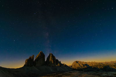 Scenic view of mountains against sky at night