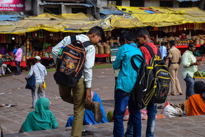 People walking on street market in city