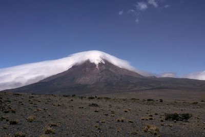 Scenic view of snowcapped mountains against blue sky