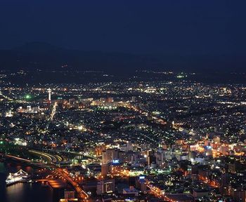 Aerial view of illuminated cityscape at night