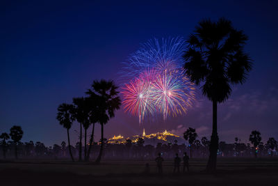 Low angle view of firework display at night