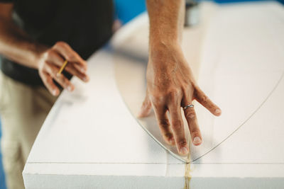 High angle view of man holding hands on tiled floor