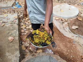 Low section of man holding food