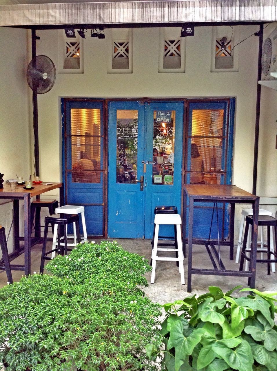 EMPTY CHAIRS AND TABLE OUTSIDE HOUSE