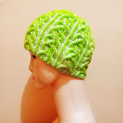 Close-up of woman holding leaf against wall