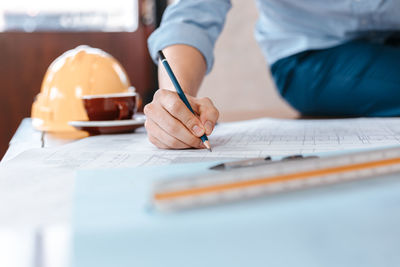 Midsection of woman working on table